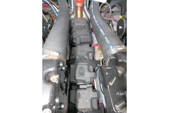 Slide: The Image of Engine components of a 1988 Sea Ray 300 Weekender boat, featuring hoses and wiring. - 34