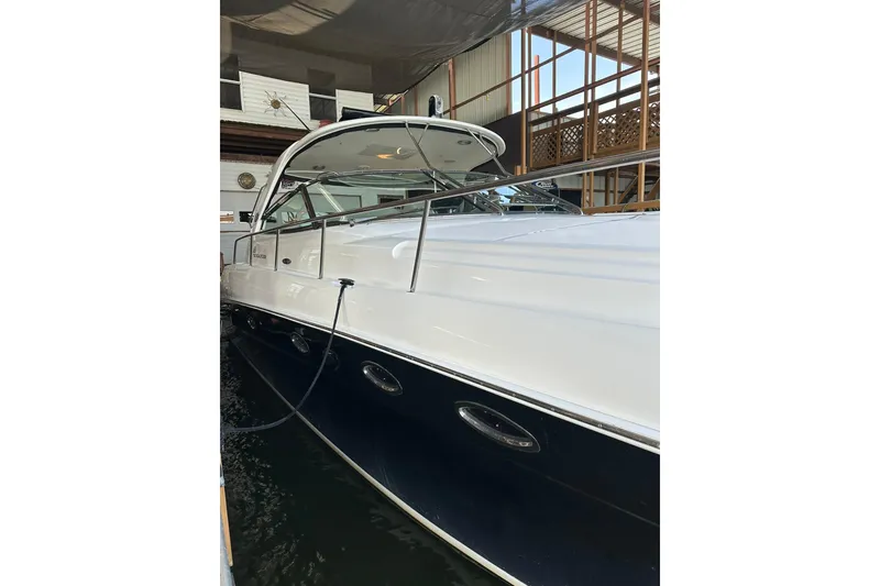 Slide: The Image of 2003 Sea Ray 460 Sundancer yacht docked indoors, showcasing sleek design and luxury features. - 1