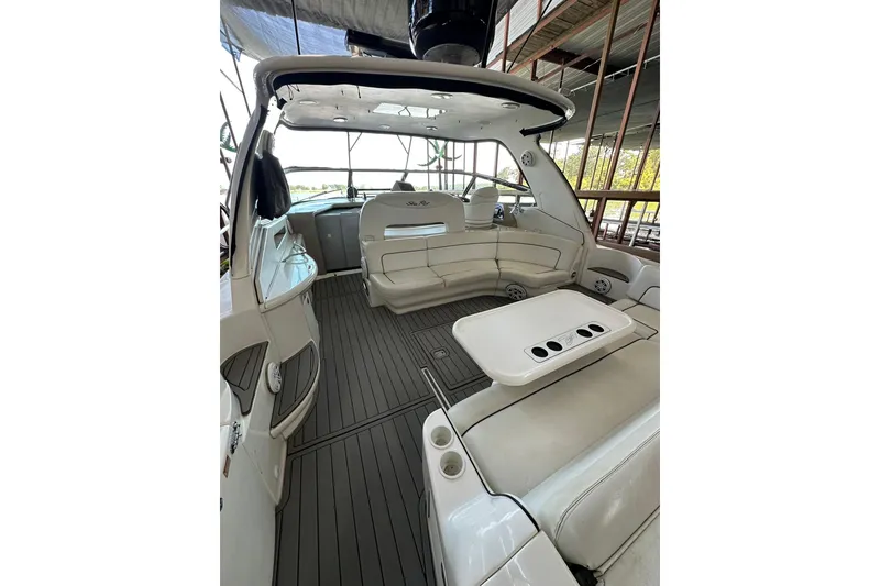 Slide: The Image of 2003 Sea Ray 460 Sundancer yacht interior with white seating and table. - 16