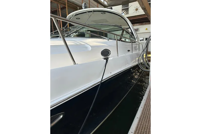 Slide: The Image of 2003 Sea Ray 460 Sundancer yacht docked in a marina, side view. - 19