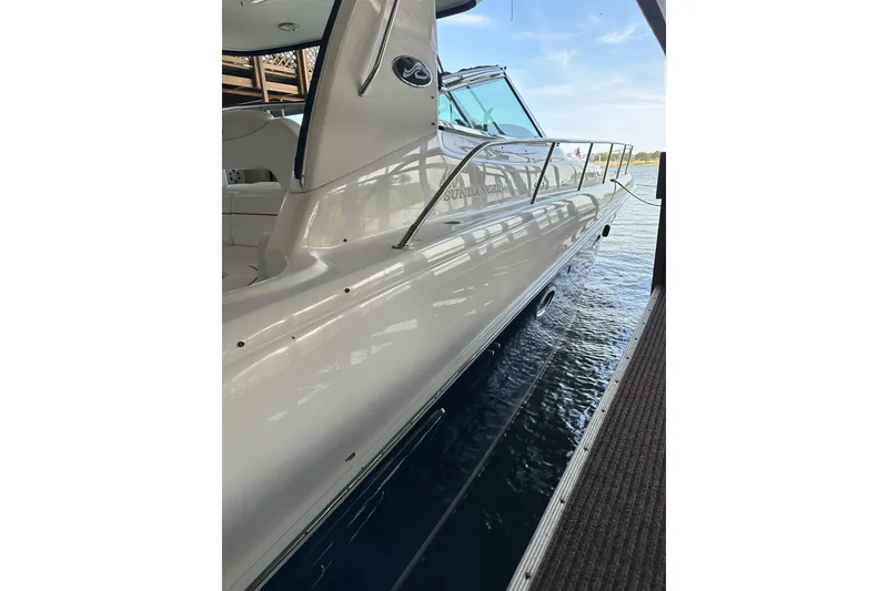 Slide: The Image of 2003 Sea Ray 460 Sundancer yacht docked, showcasing sleek design and polished exterior. - 2