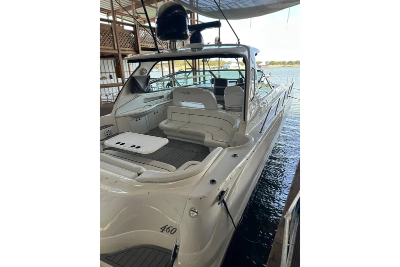 Slide: The Image of 2003 Sea Ray 460 Sundancer yacht docked, featuring spacious seating and sleek design. - 3