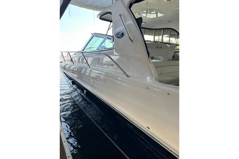 Slide: The Image of 2003 Sea Ray 460 Sundancer yacht docked, showcasing sleek design and luxurious interior. - 5