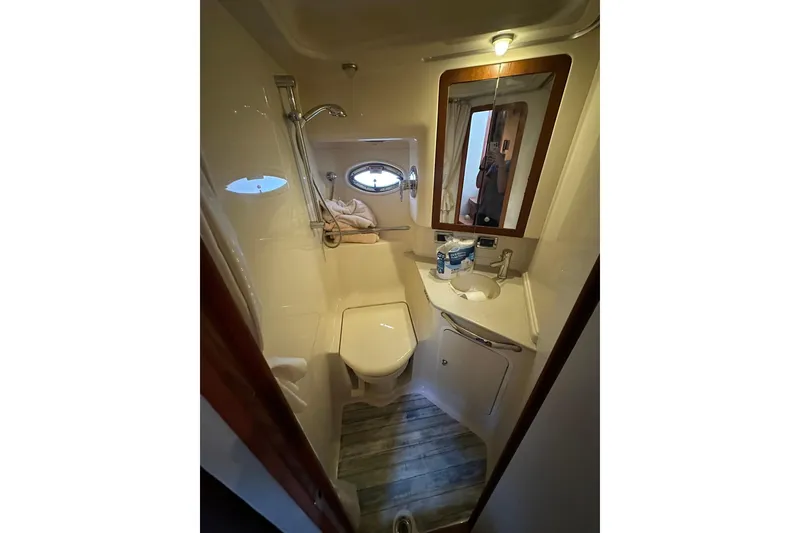 Slide: The Image of Compact bathroom in 2003 Sea Ray 460 Sundancer yacht with shower, sink, and mirror. - 6