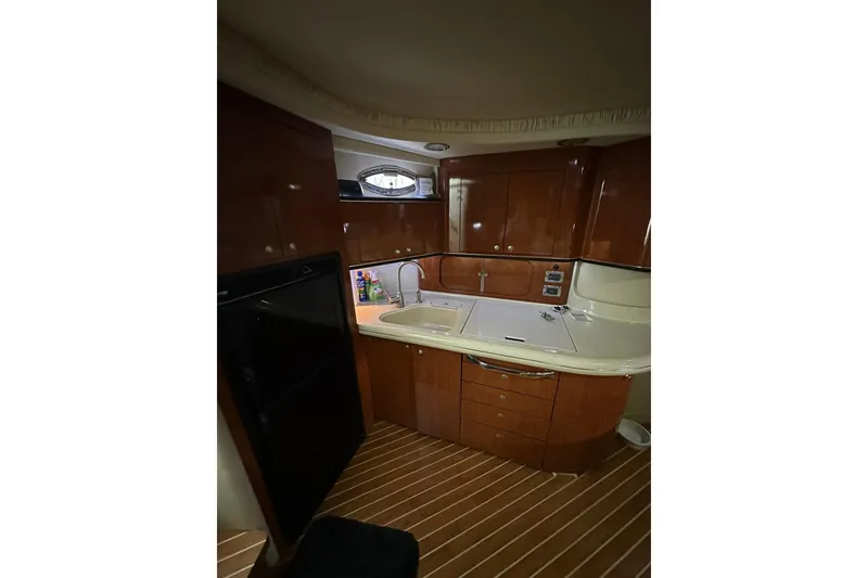 Slide: The Image of Luxurious 2003 Sea Ray 460 Sundancer yacht kitchen with wood cabinetry and modern amenities. - 9