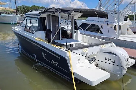The Image of 2024 Jeanneau NC Weekender 795 Series 2 docked, featuring Yamaha outboard motor. - 0