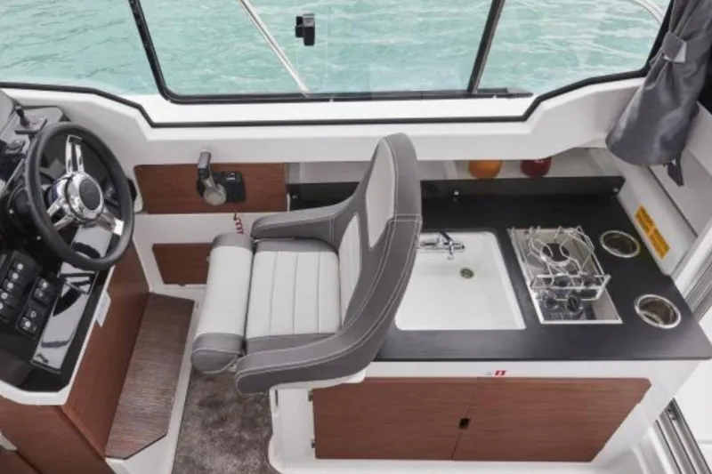 Slide: The Image of 2024 Jeanneau NC Weekender 795 Series 2 interior with helm, sink, and seating. - 11