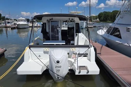 Slide: The Image of 2024 Jeanneau NC Weekender 795 Series 2 docked at marina under clear sky. - 3