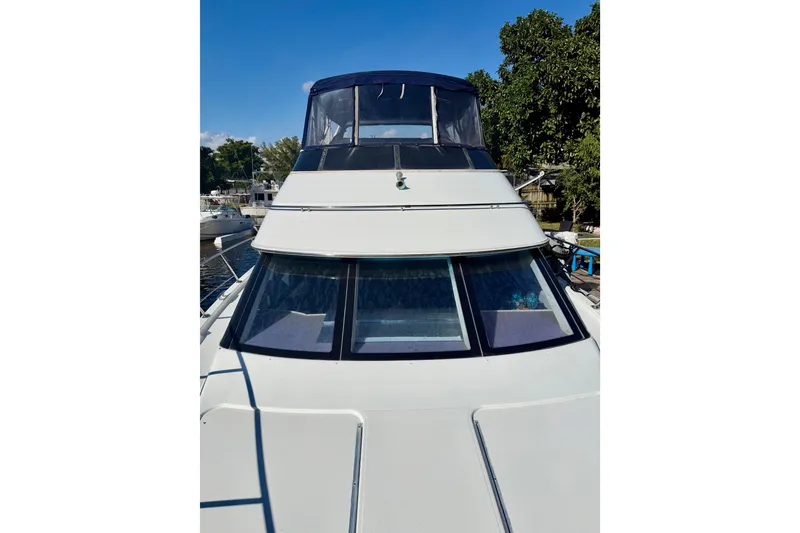 Slide: The Image of 2002 Carver 444 Cockpit Motor Yacht docked, featuring sleek design and spacious cockpit. - 21