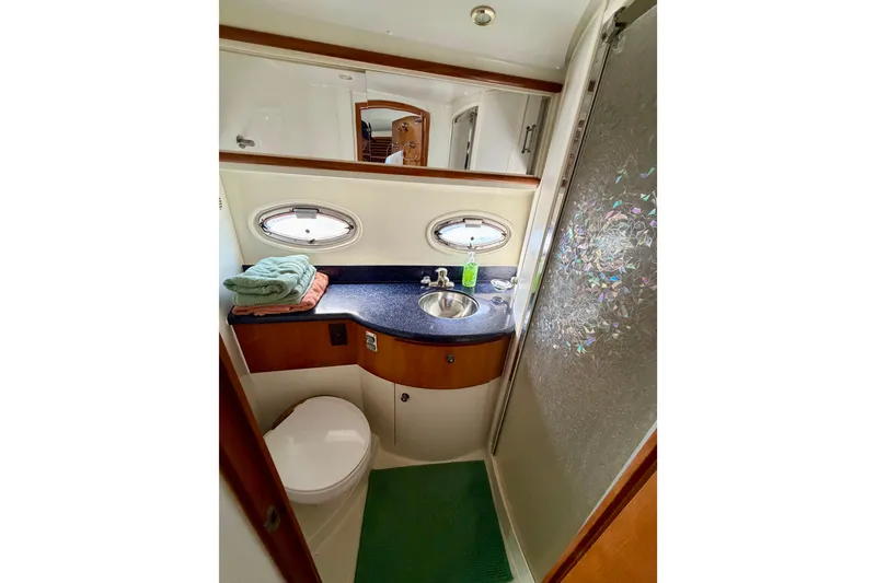 Slide: The Image of Bathroom interior of 2002 Carver 444 Cockpit Motor Yacht with sink and shower. - 22