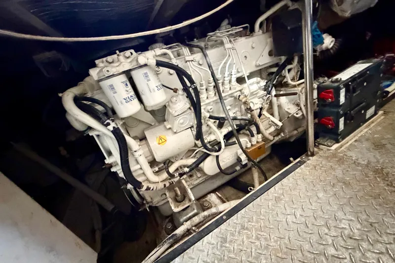 Slide: The Image of Engine room of 2002 Carver 444 Cockpit Motor Yacht with visible machinery components. - 25