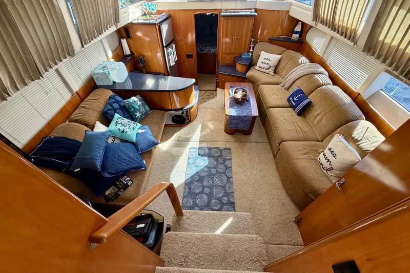 Slide: The Image of Luxurious interior of 2002 Carver 444 Cockpit Motor Yacht with cozy seating and nautical decor. - 3