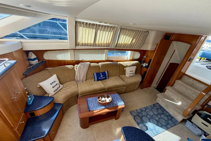 Slide: The Image of Luxurious interior of 2002 Carver 444 Cockpit Motor Yacht with cozy seating area. - 4