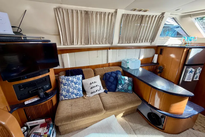 Slide: The Image of Interior of 2002 Carver 444 Cockpit Motor Yacht with cozy seating and nautical decor. - 5