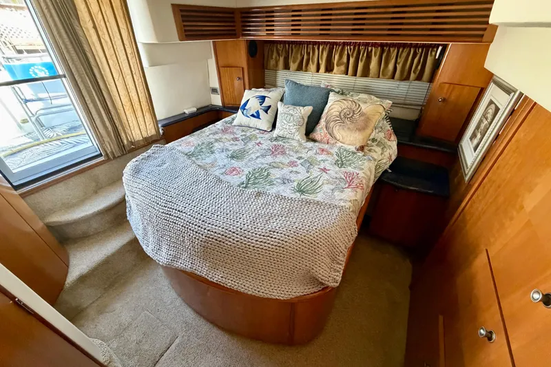 Slide: The Image of Luxurious bedroom interior of 2002 Carver 444 Cockpit Motor Yacht with cozy bedding. - 13