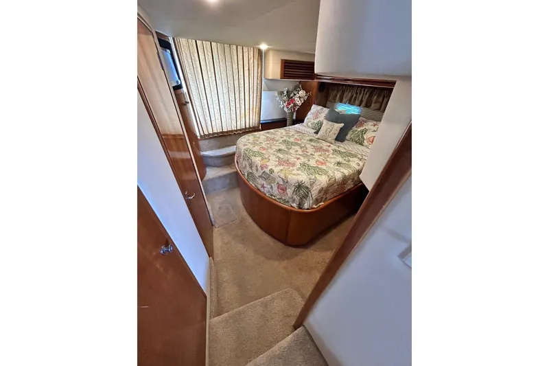 Slide: The Image of Luxurious bedroom in 2002 Carver 444 Cockpit Motor Yacht with floral bedding. - 14