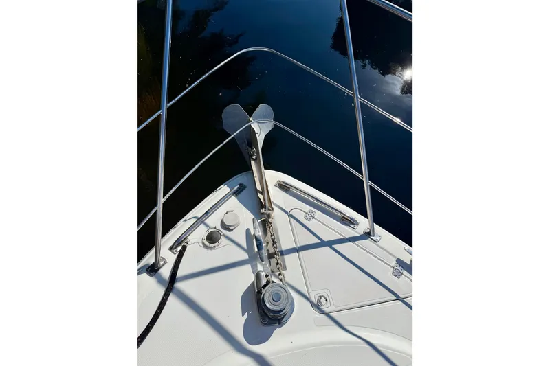 Slide: The Image of Bow view of 2002 Carver 444 Cockpit Motor Yacht with anchor and railing. - 19