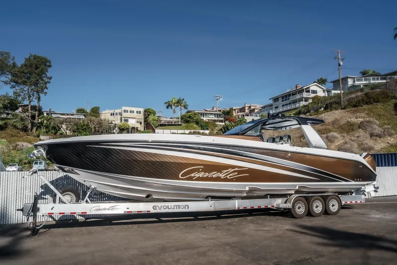 The Image of 2024 Cigarette 42 Auroris luxury boat on trailer, sleek design, coastal background. - 0