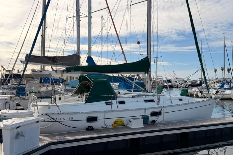 Slide: The Image of 1995 Beneteau Oceanis 351 sailboat docked at marina under blue sky. - 10