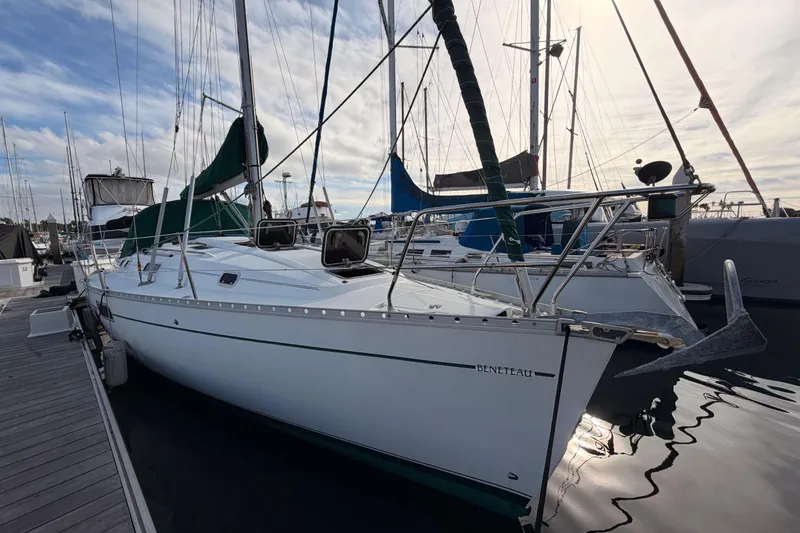 Slide: The Image of 1995 Beneteau Oceanis 351 sailboat docked at marina under cloudy sky. - 11