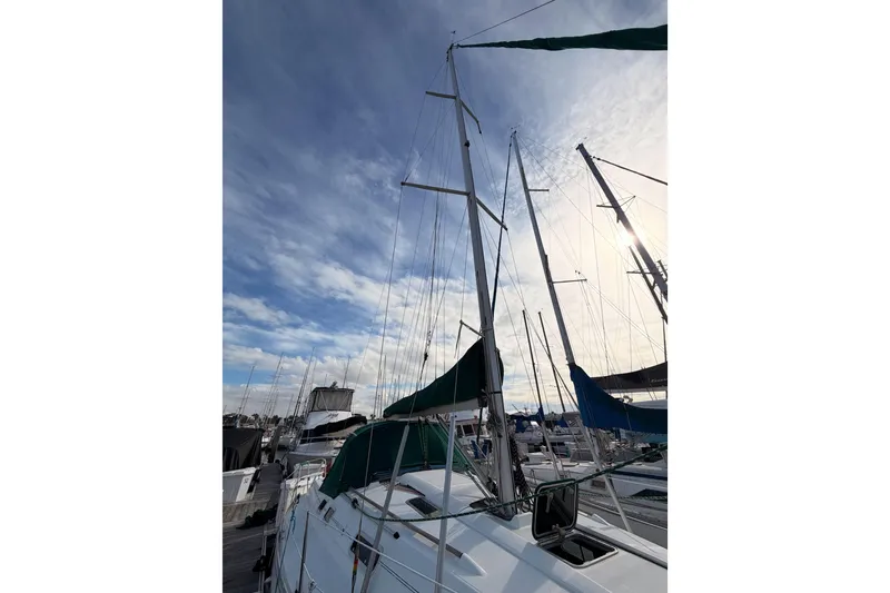Slide: The Image of Sailboat Beneteau Oceanis 351, 1995 model, docked under a partly cloudy sky. - 12