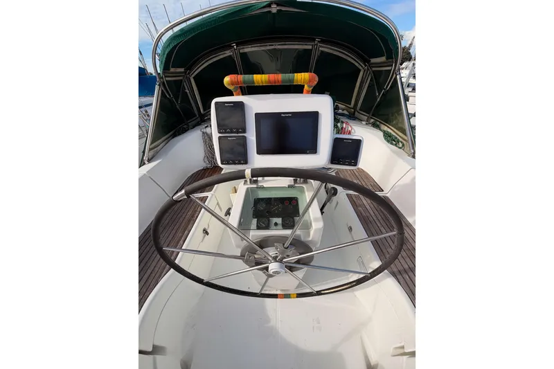 Slide: The Image of Cockpit of 1995 Beneteau Oceanis 351 sailboat with steering wheel and navigation equipment. - 17