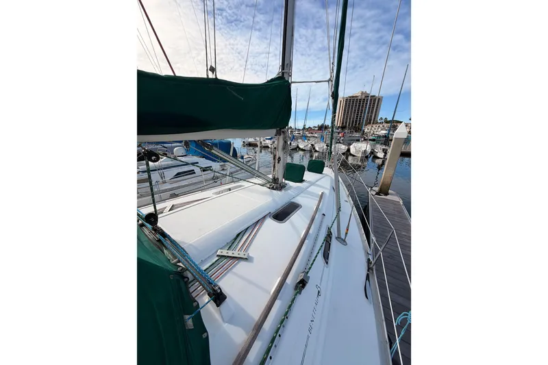 Slide: The Image of 1995 Beneteau Oceanis 351 sailboat docked at marina under blue sky. - 22