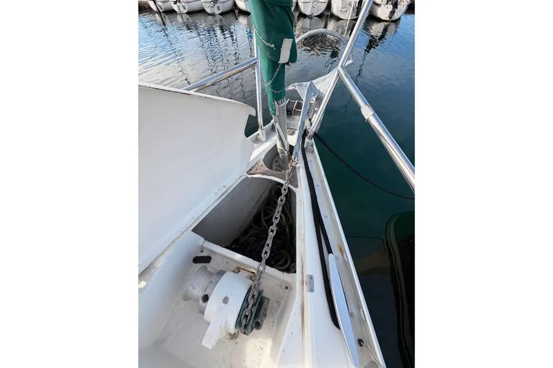 Slide: The Image of Bow of 1995 Beneteau Oceanis 351 sailboat with anchor chain and winch. - 24
