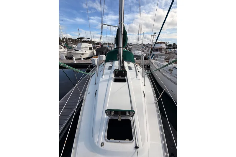Slide: The Image of 1995 Beneteau Oceanis 351 sailboat docked at marina under blue sky. - 25