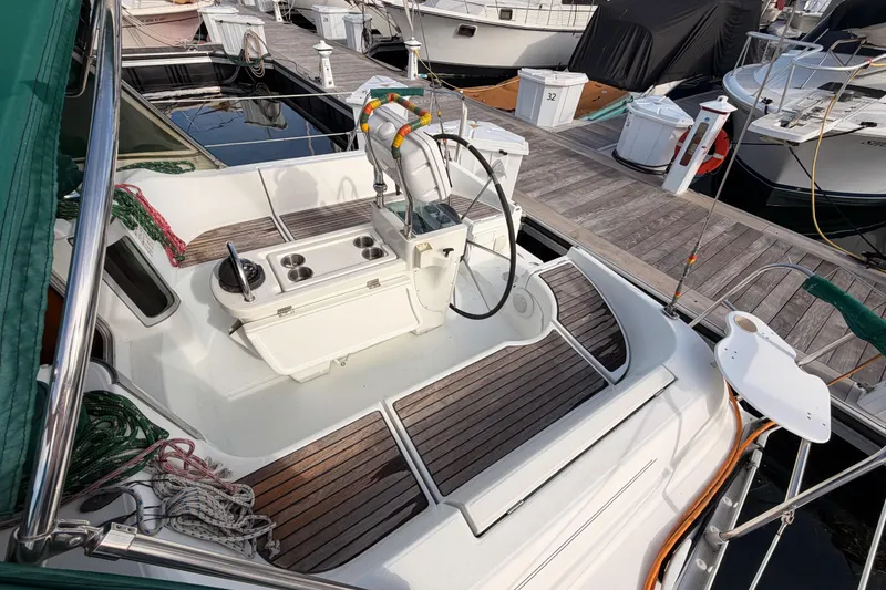 Slide: The Image of Beneteau Oceanis 351 sailboat cockpit with wooden deck, docked at marina, 1995 model. - 29