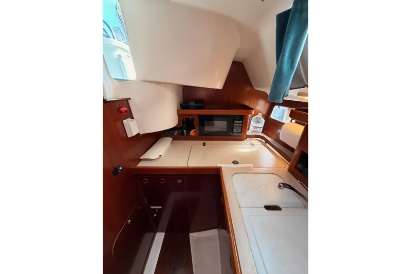 Slide: The Image of Interior of 1995 Beneteau Oceanis 351 sailboat with kitchenette and microwave. - 36