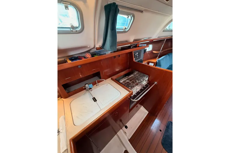 Slide: The Image of Interior of 1995 Beneteau Oceanis 351 yacht, featuring a compact kitchen area. - 39