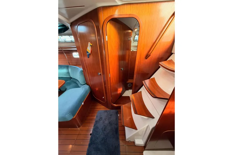 Slide: The Image of Interior of 1995 Beneteau Oceanis 351 sailboat with wooden finish and blue seating. - 41