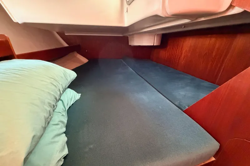 Slide: The Image of Cozy cabin interior of 1995 Beneteau Oceanis 351 sailboat with blue bedding. - 43