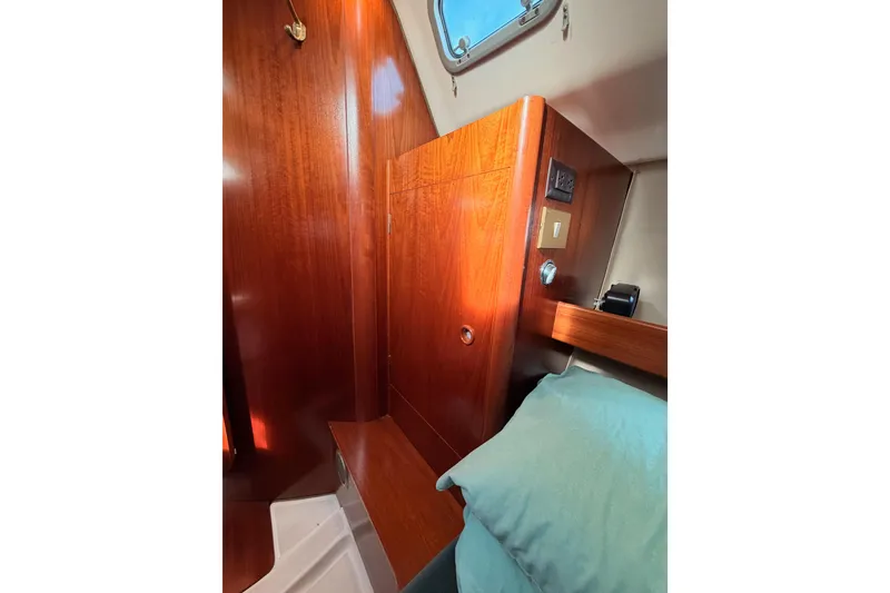 Slide: The Image of Interior cabin of 1995 Beneteau Oceanis 351 with wooden paneling and bedding. - 44