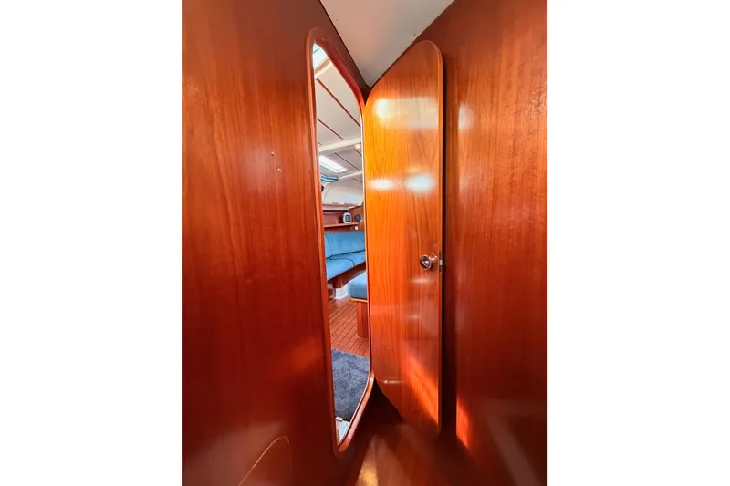Slide: The Image of Interior view of 1995 Beneteau Oceanis 351 sailboat with wooden door and cozy cabin. - 45