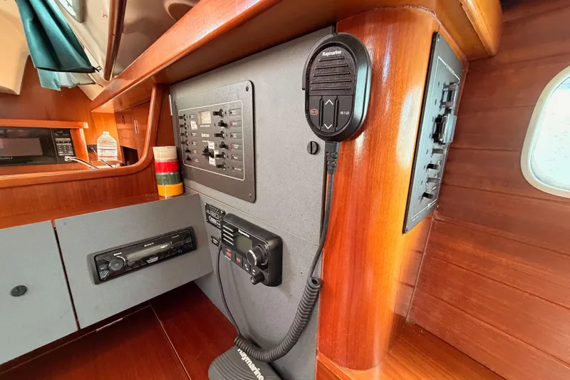 Slide: The Image of Interior of 1995 Beneteau Oceanis 351 sailboat with control panel and radio equipment. - 48
