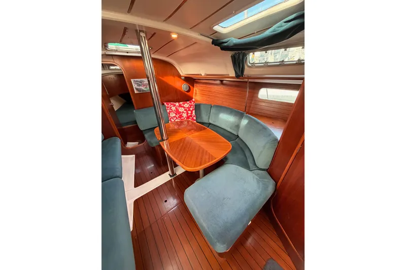 Slide: The Image of Interior of 1995 Beneteau Oceanis 351 sailboat with cozy seating and wooden finishes. - 49