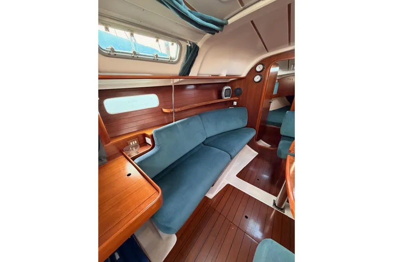Slide: The Image of Interior of 1995 Beneteau Oceanis 351 sailboat with wood finish and blue upholstery. - 51