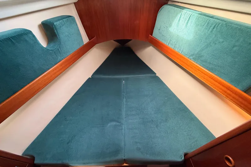 Slide: The Image of Interior cabin of 1995 Beneteau Oceanis 351 sailboat with teal cushions and wooden trim. - 55