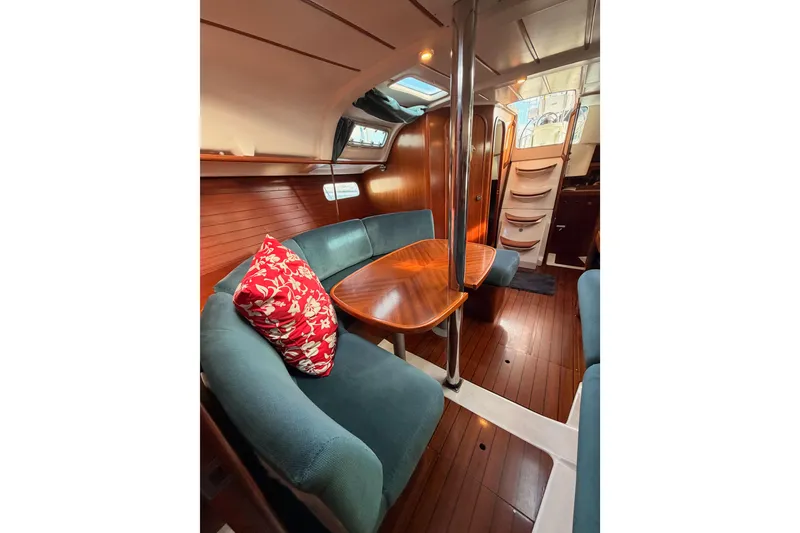 Slide: The Image of Interior of 1995 Beneteau Oceanis 351 sailboat with wooden finish and cozy seating. - 58