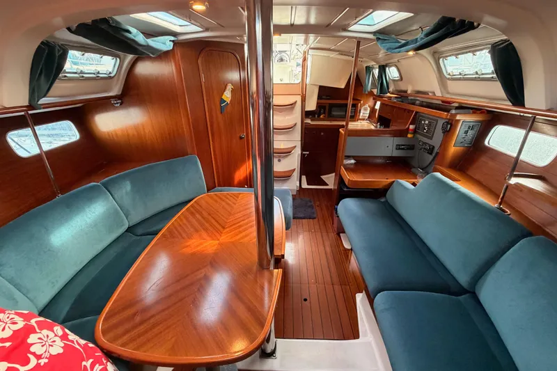 Slide: The Image of Interior of 1995 Beneteau Oceanis 351 sailboat with wood finish and blue seating. - 59