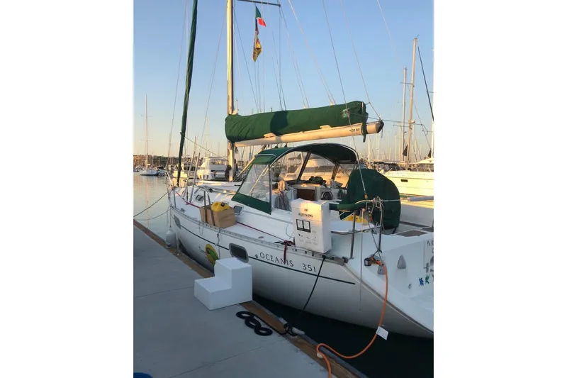Slide: The Image of 1995 Beneteau Oceanis 351 sailboat docked at marina during sunset. - 6