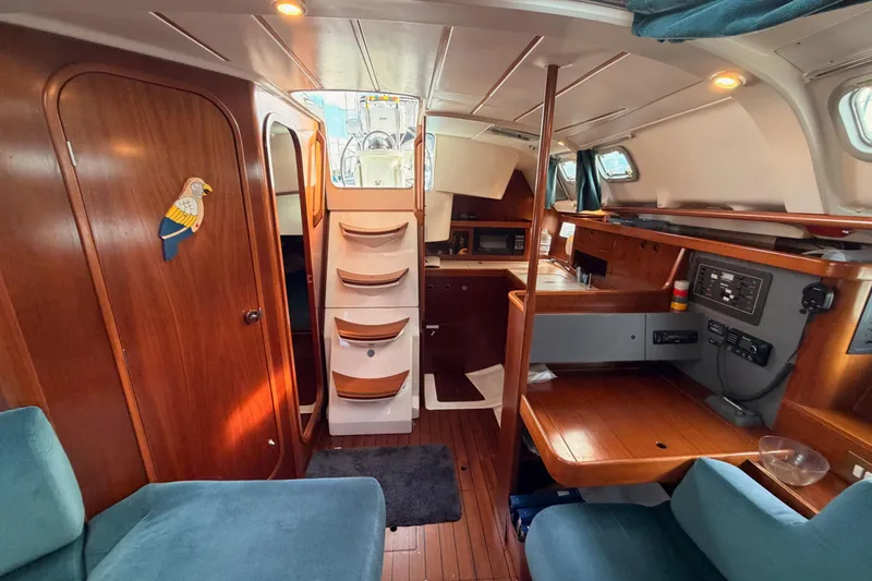 Slide: The Image of Interior of 1995 Beneteau Oceanis 351 sailboat with wood finish and cozy seating. - 60