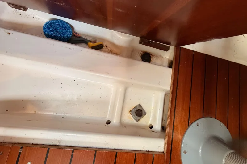 Slide: The Image of Interior view of a 1995 Beneteau Oceanis 351 sailboat with wooden flooring and cleaning tools. - 62