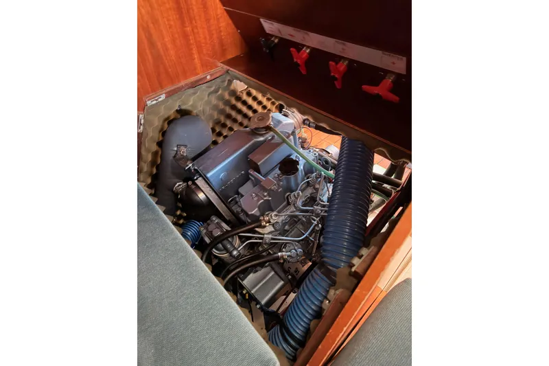 Slide: The Image of Engine compartment of a 1995 Beneteau Oceanis 351 sailboat, showcasing mechanical components. - 64