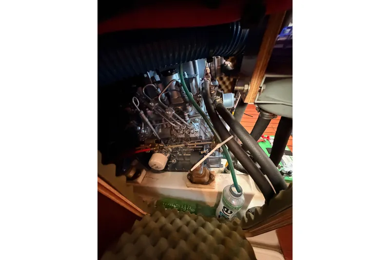 Slide: The Image of Engine compartment of a 1995 Beneteau Oceanis 351 sailboat, showing hoses and components. - 67