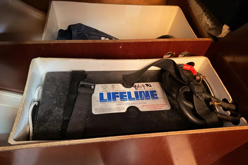 Slide: The Image of Battery compartment in 1995 Beneteau Oceanis 351 sailboat, featuring Lifeline deep cycle battery. - 68