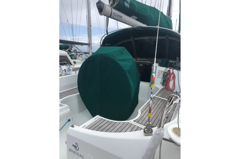 Slide: The Image of 1995 Beneteau Oceanis 351 sailboat cockpit with green cover and visible ropes. - 73