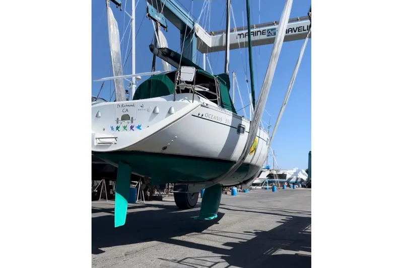 Slide: The Image of 1995 Beneteau Oceanis 351 sailboat in dry dock, showcasing hull and keel. - 9